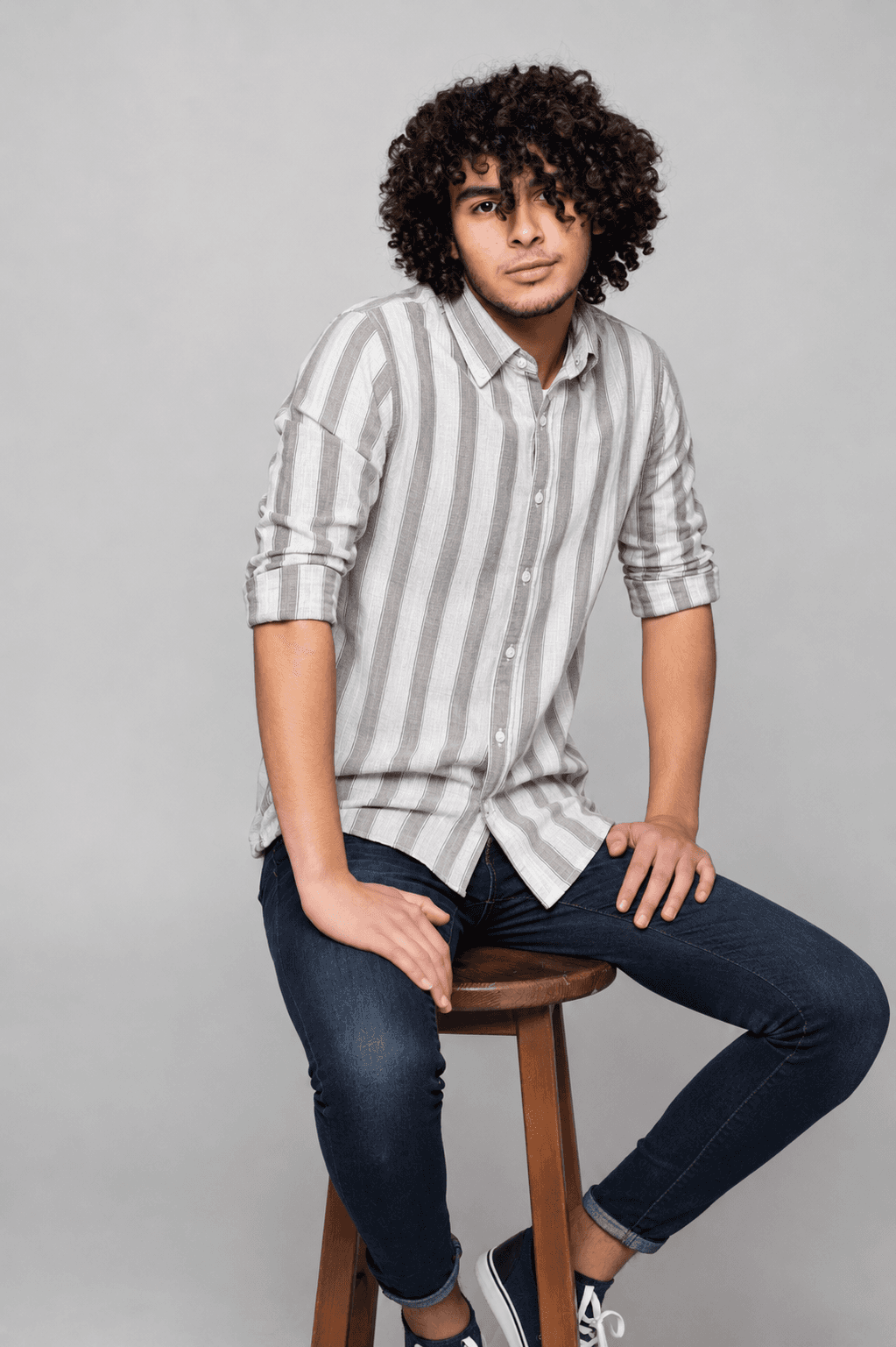 Model wearing a white and grey vertical striped linen shirt